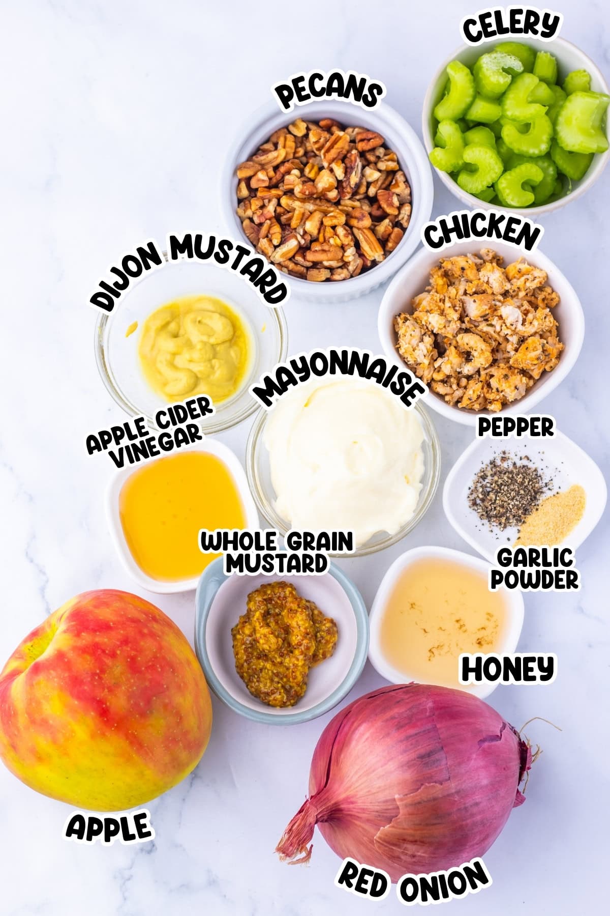 Chicken salad ingredients in bowls: apple, pecans, celery, onion, mustards, mayo, spices.