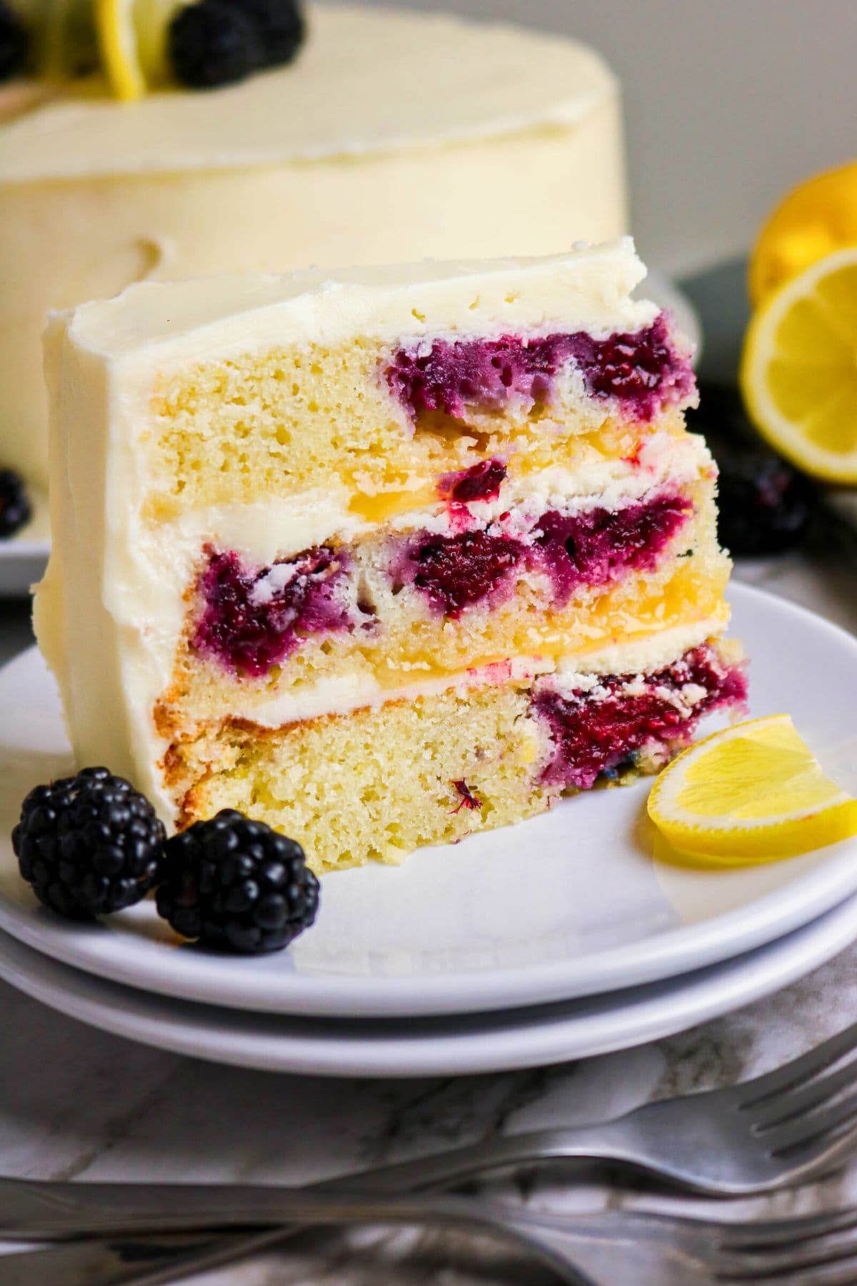 A slice of lemon blackberry cake, perfect for fans of blackberry recipes.