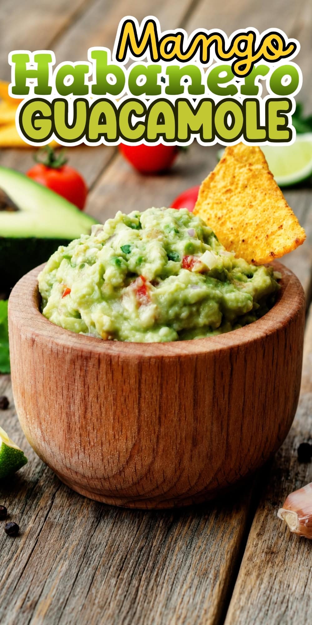 Wooden bowl of guacamole with a tortilla chip.