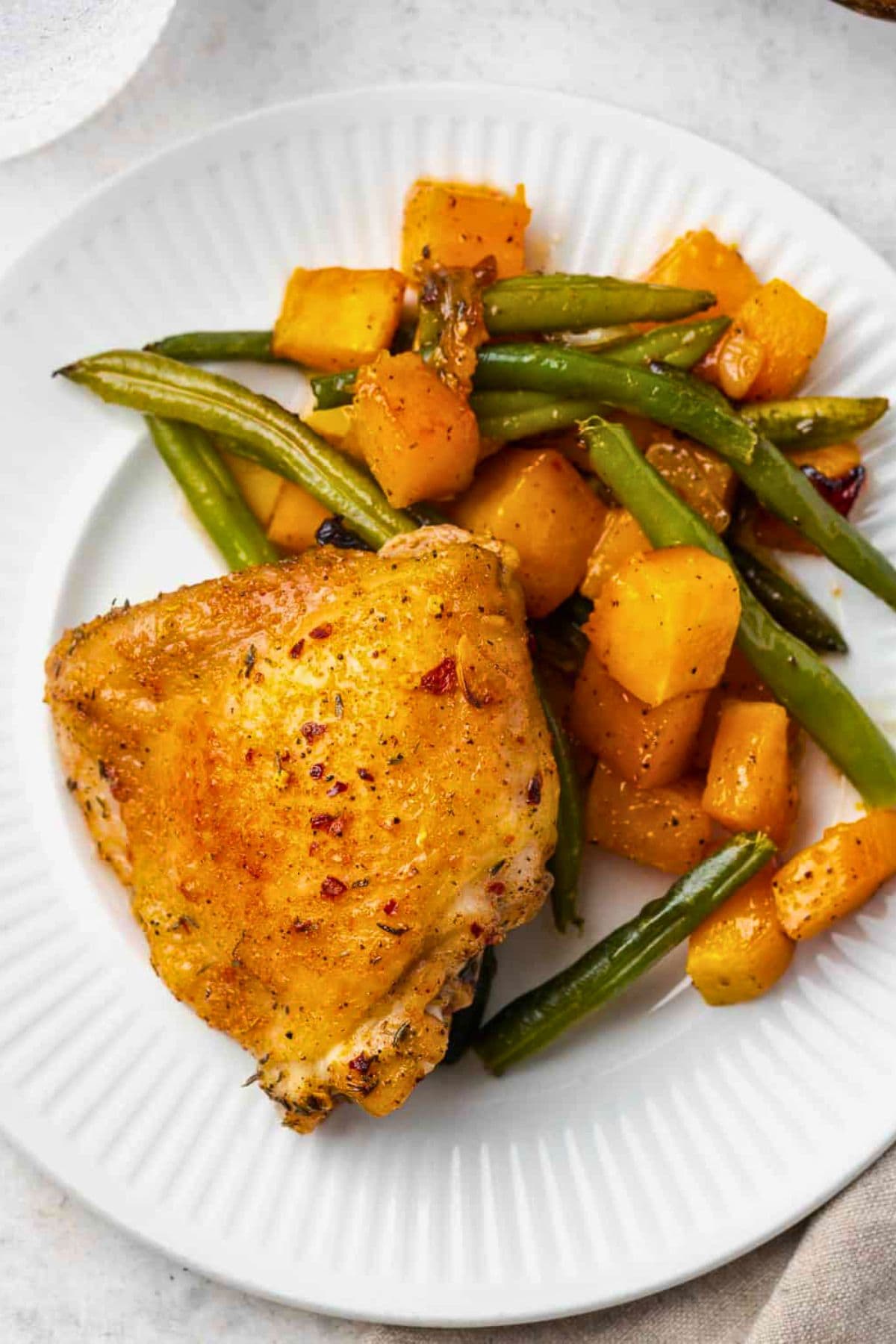 Sheet pan dinner recipes: Roast chicken thigh with green beans and roasted squash.