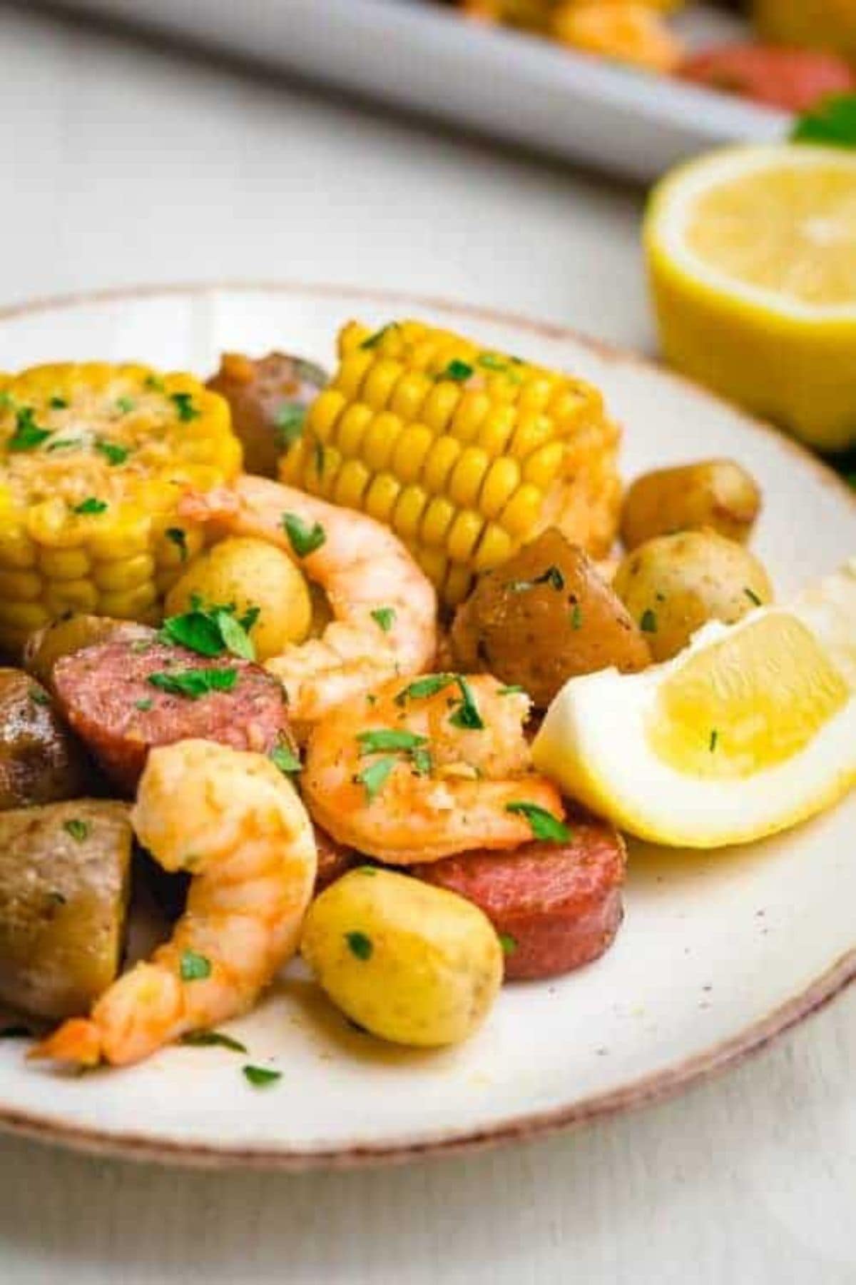 Plate with shrimp, sausage, corn, and potatoes—classic sheet pan dinner recipe.