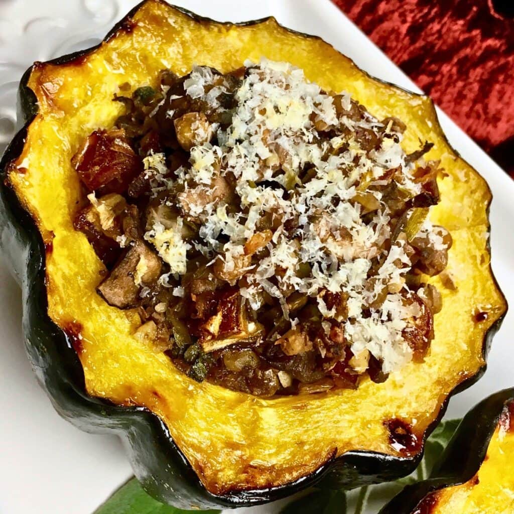 Baked acorn squash stuffed with vegetables and topped with grated cheese.
