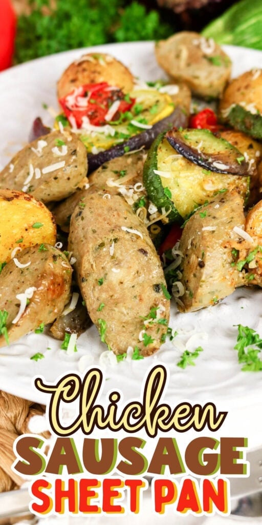 Chicken sausage with roasted vegetables on a white plate, garnished with herbs.