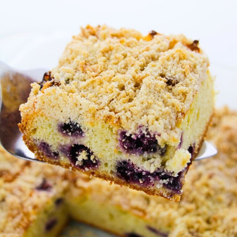 A slice of berry crumb cake with a golden, crumbly topping.