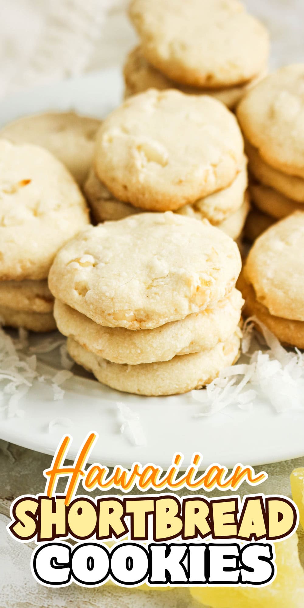 A plate of stacked Hawaiian shortbread cookies on a white plate.