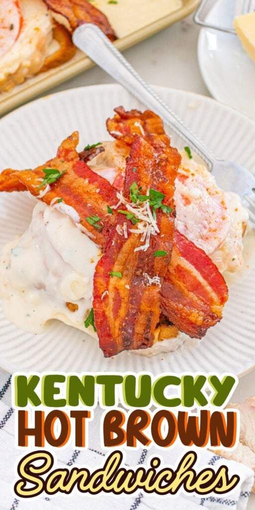 Two bacon-topped sandwiches covered in creamy sauce on a white plate.