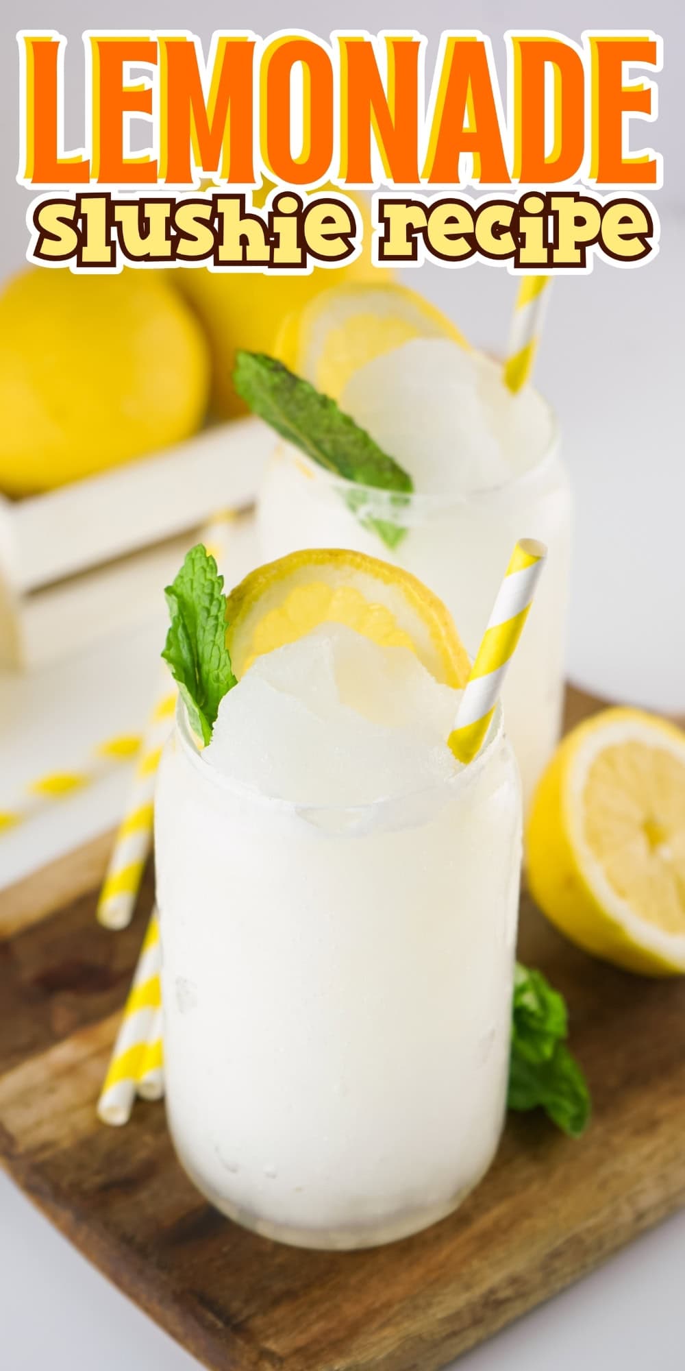 Two jars of lemonade slushies with lemon slices, mint, and striped straws.