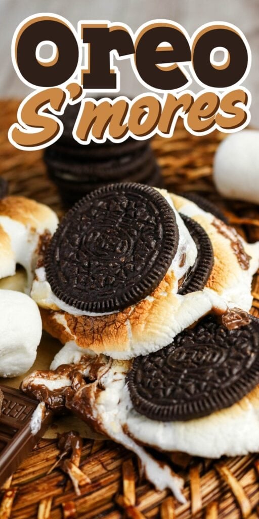 Oreo smores with toasted marshmallow and chocolate on a woven mat.