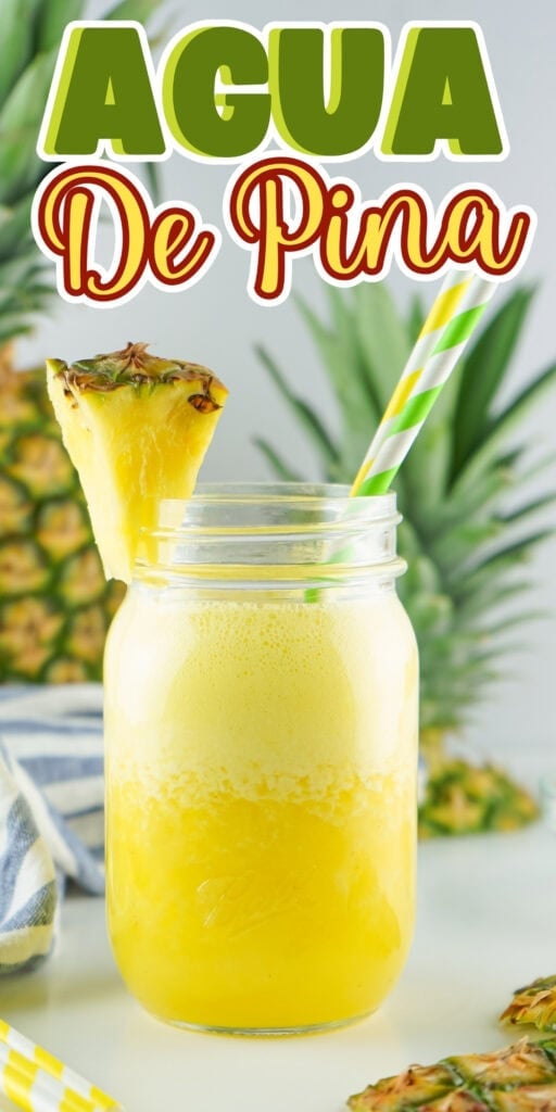 Mason jar of pineapple agua fresca with straw and pineapple garnish.
