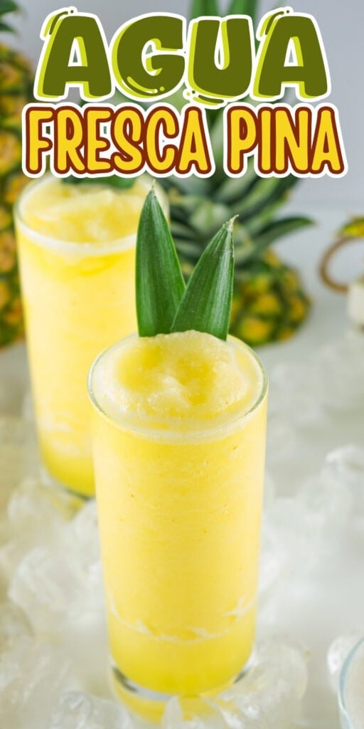 Yellow pineapple agua fresca in tall glasses, garnished with pineapple leaves.