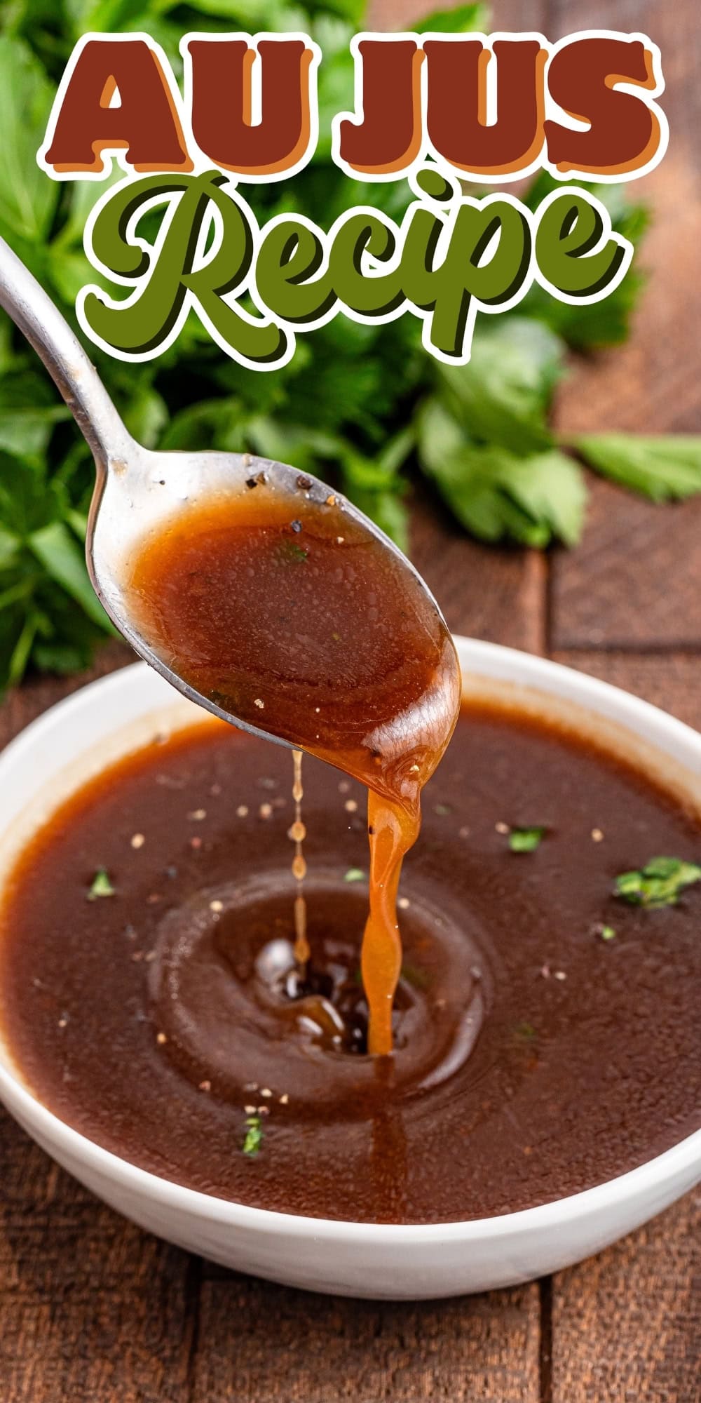 Spoon pouring au jus sauce into a bowl, with parsley in the background.