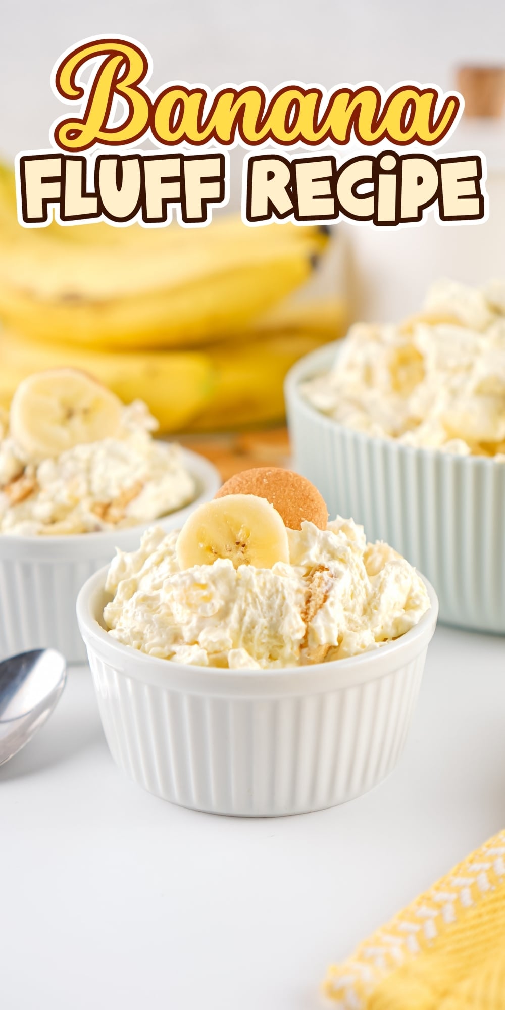 Banana fluff dessert in white ramekins, topped with banana slices and wafers.
