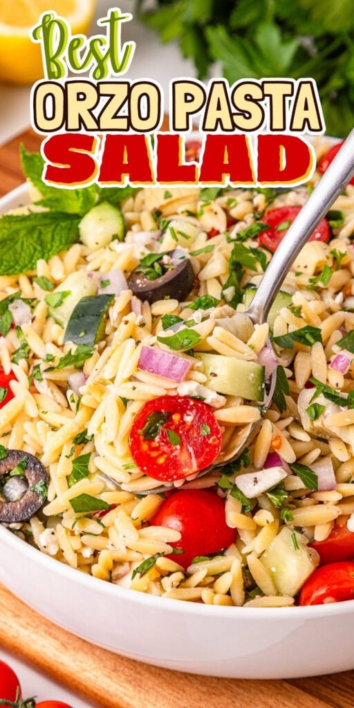 Bowl of orzo pasta salad with veggies, herbs, and a spoon.