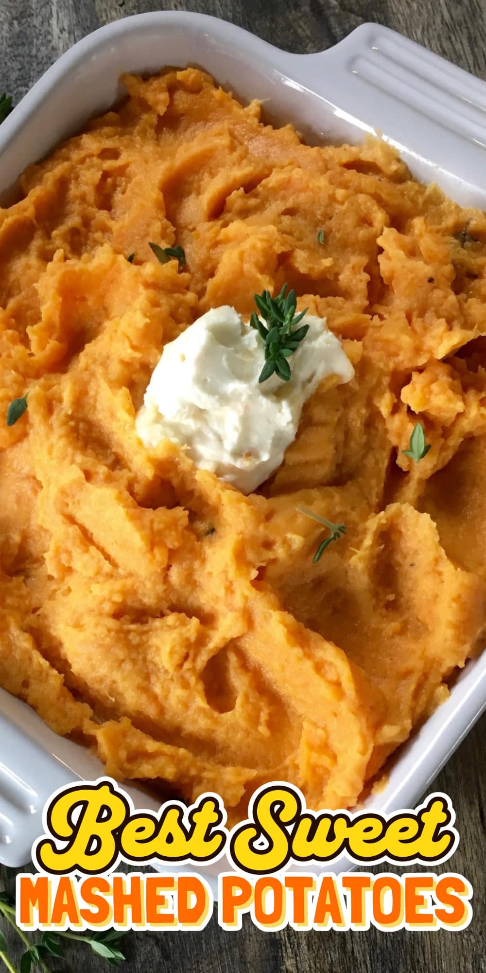 Mashed sweet potatoes in a dish, topped with butter and a sprig of herbs.