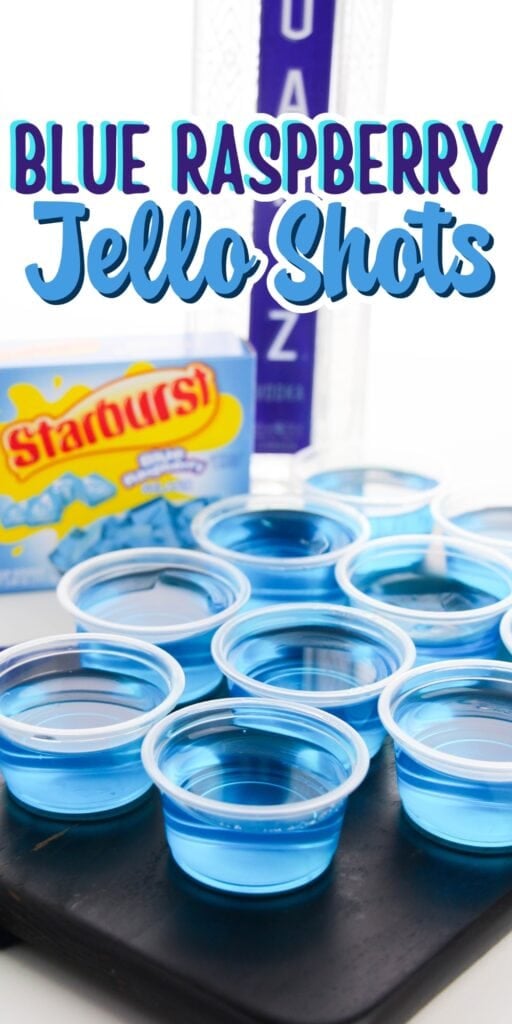 Blue raspberry jello shots in cups with Starburst and vodka bottles behind.