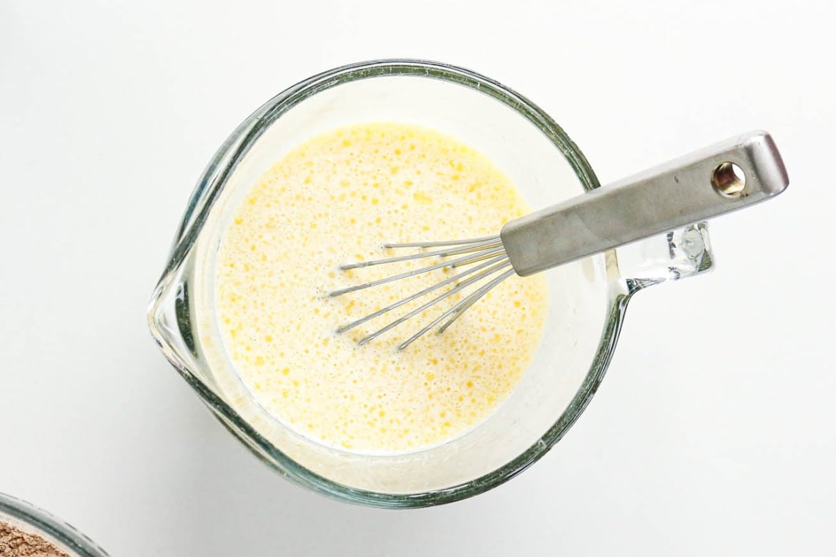 Whisking wet ingredients in bowl.
