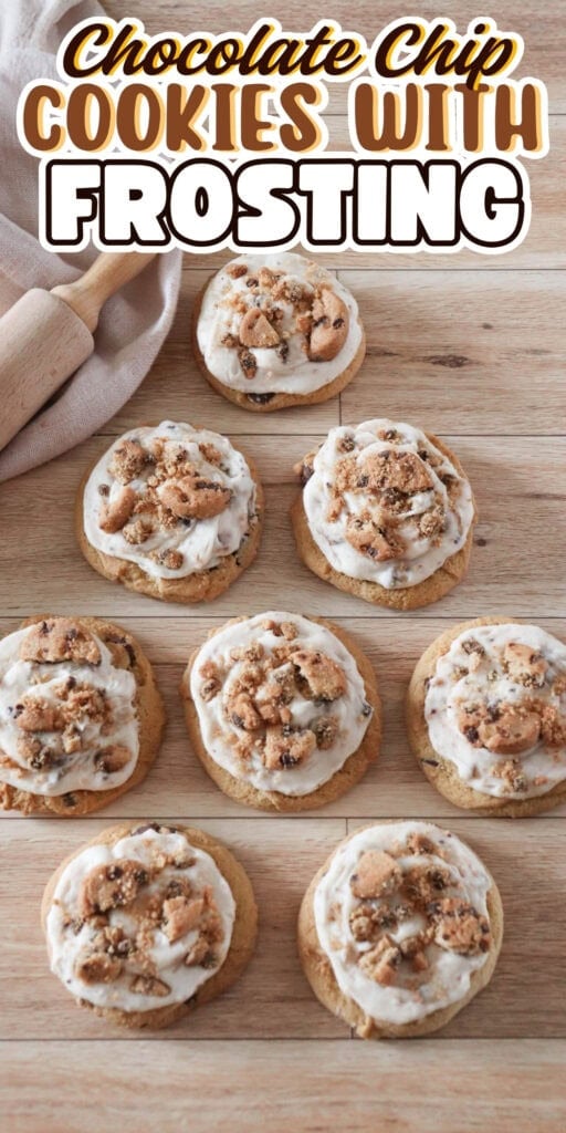 Eight chocolate chip cookies with frosting on a wooden surface.