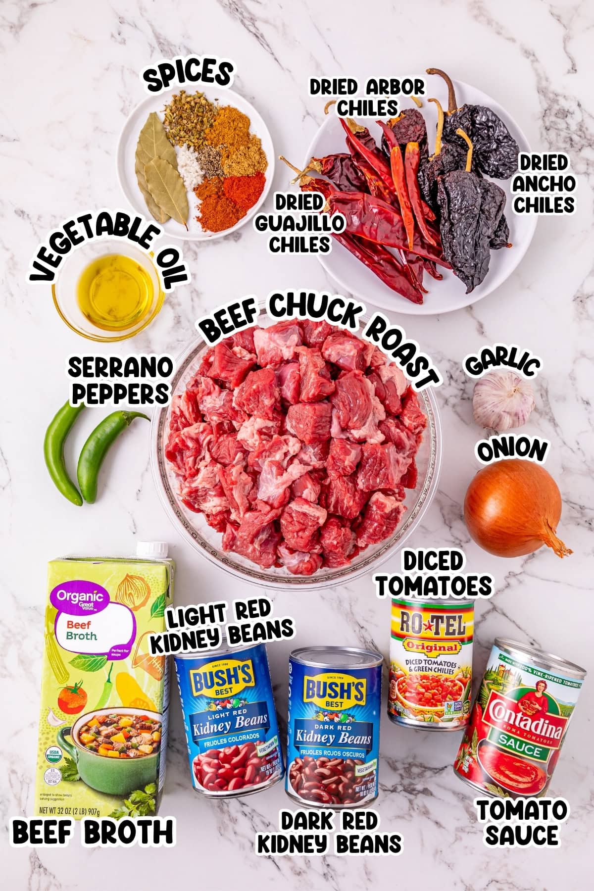 Ingredients for chili arranged on a marble counter with labels for each item.
