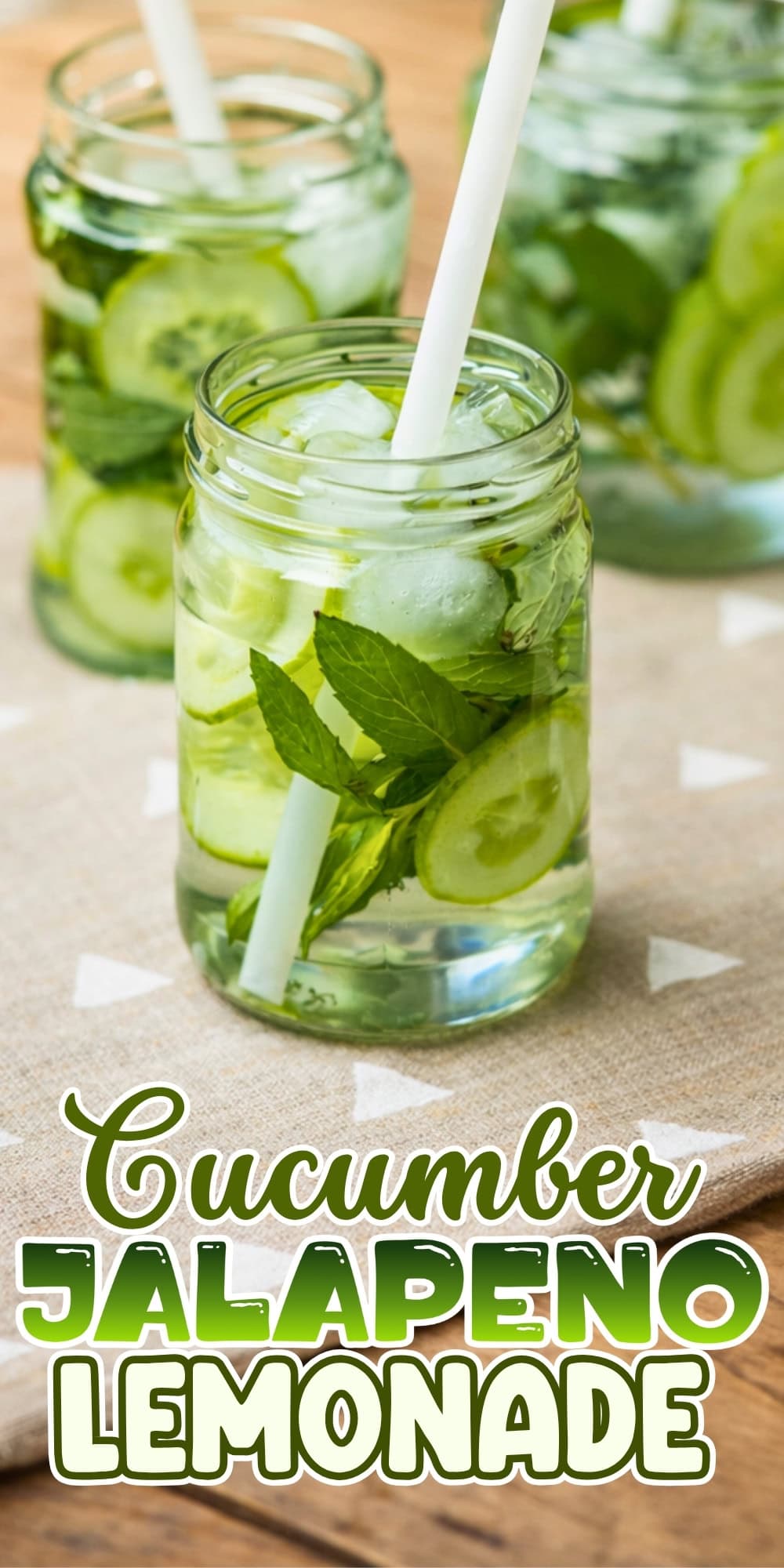 Mason jars of cucumber jalapeño lemonade with ice, mint, and straws.