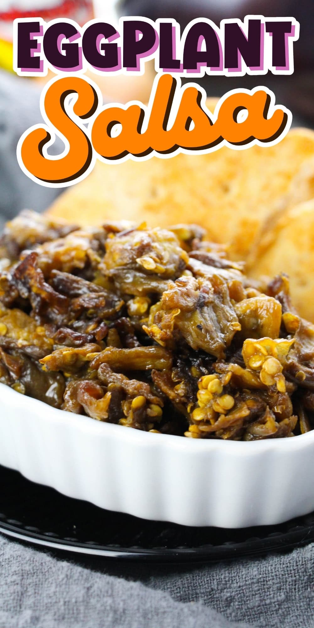Bowl of eggplant salsa with chips, text reads Eggplant Salsa above.