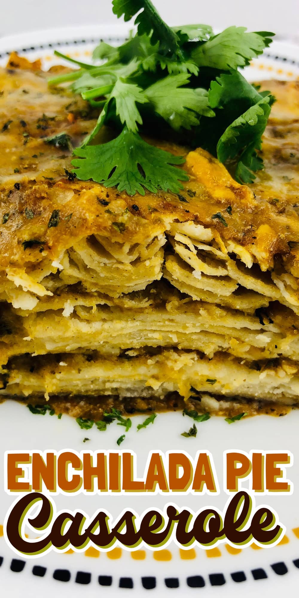 A slice of enchilada pie casserole garnished with fresh cilantro.