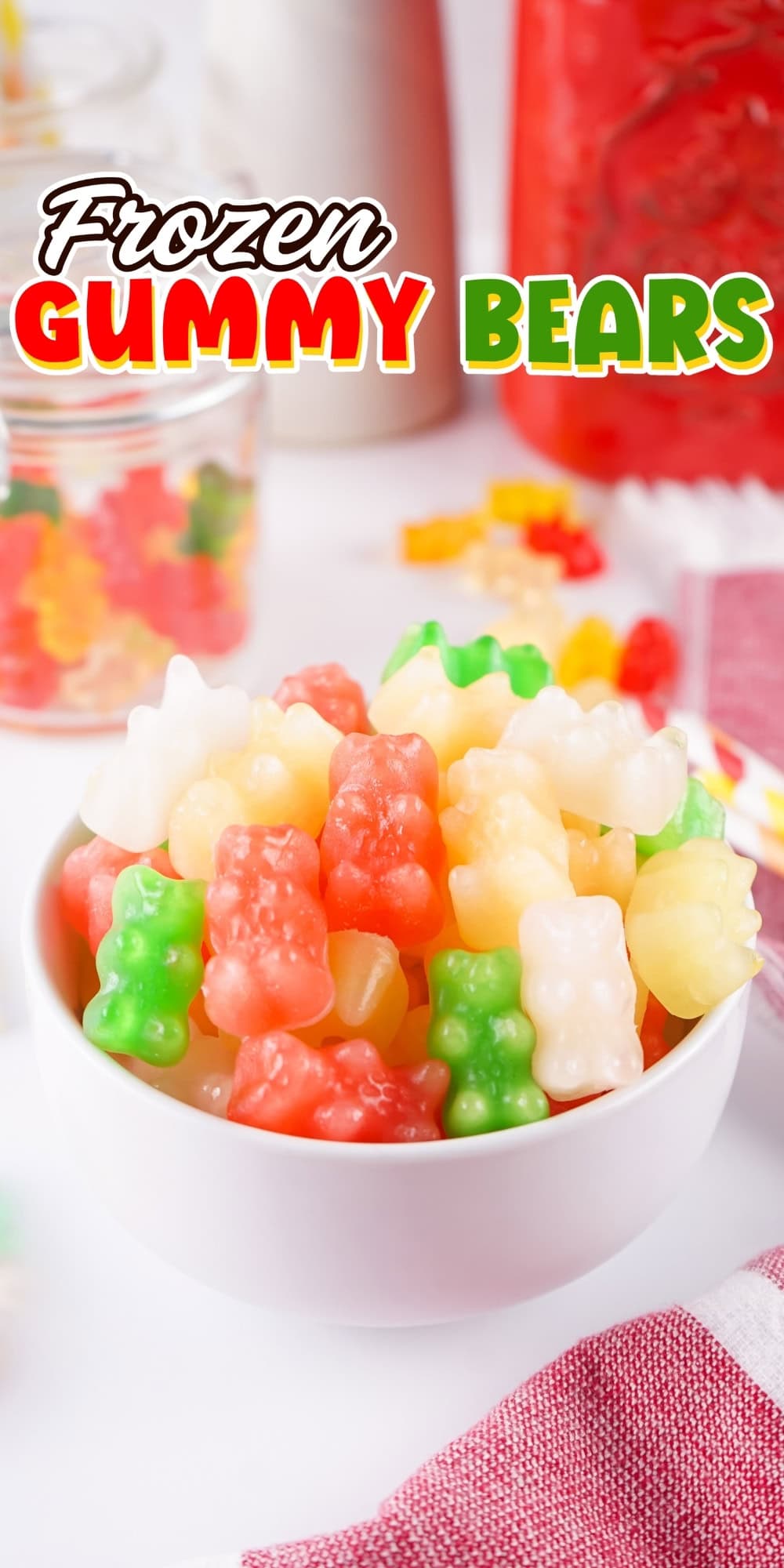 A white bowl filled with colorful gummy bears on a table.