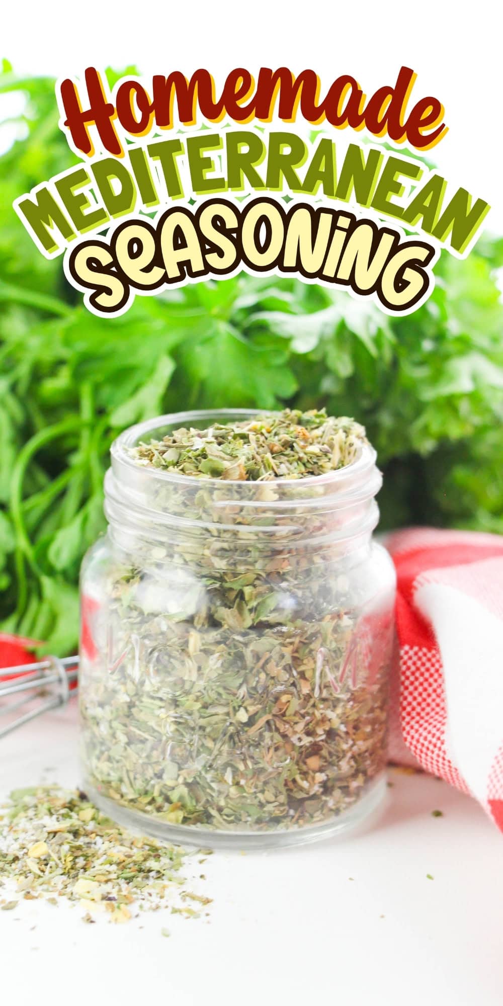 Jar of Mediterranean seasoning with herbs and a towel in the background.