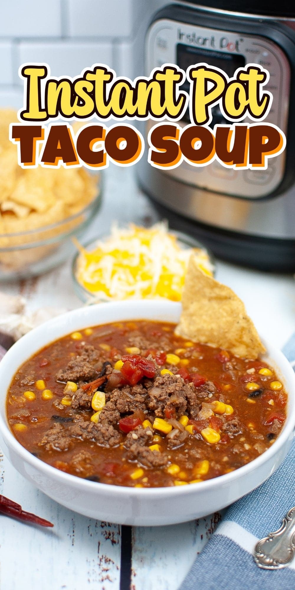 Bowl of taco soup with chips, cheese, and an Instant Pot in the background.