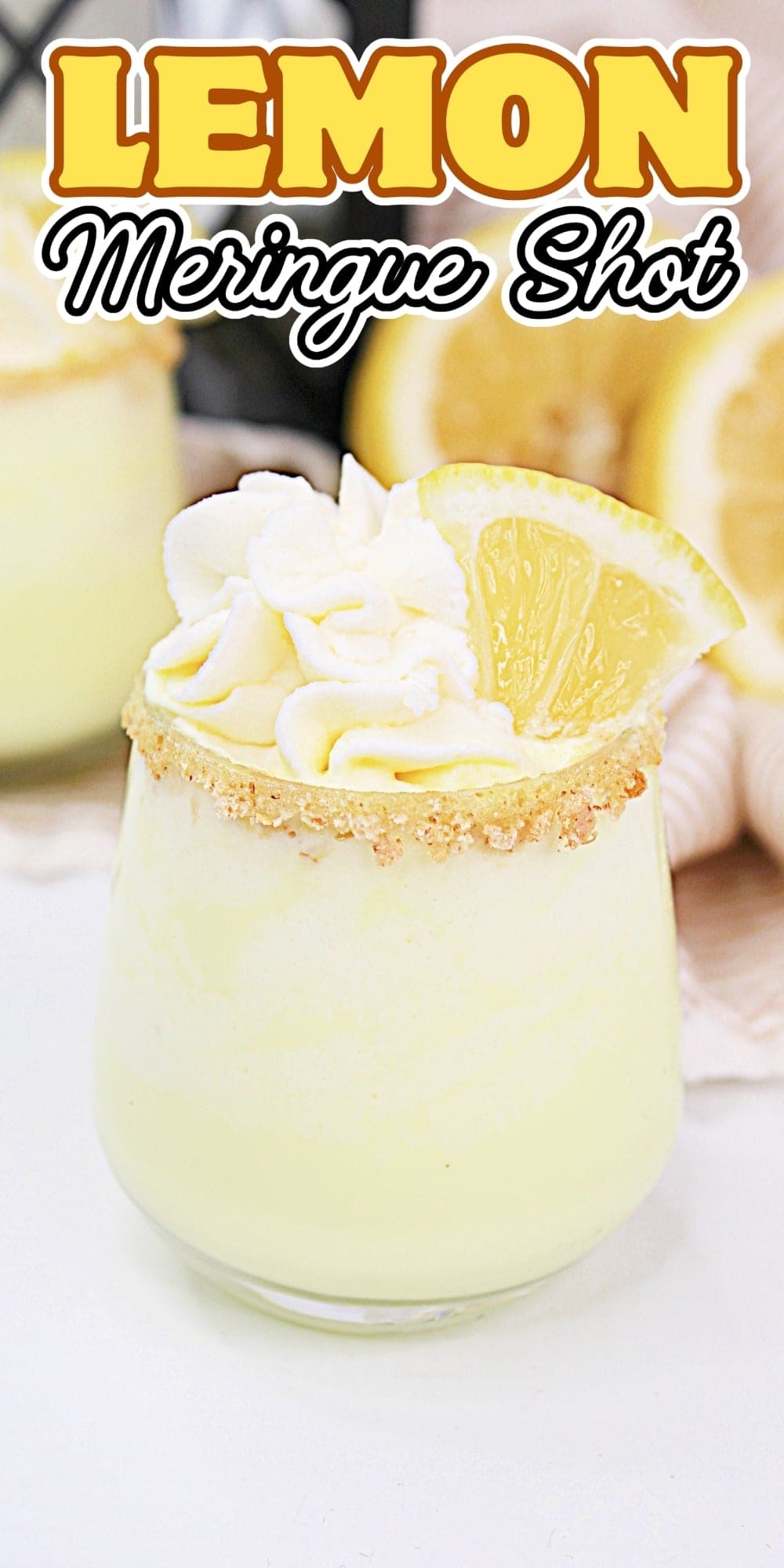 Glass with lemon dessert, whipped cream, and a lemon slice on top.