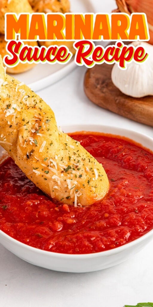 Breadstick dipped in marinara sauce.