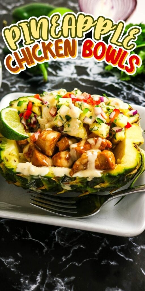 Chicken and salsa served in a halved pineapple bowl, with sauce and lime.