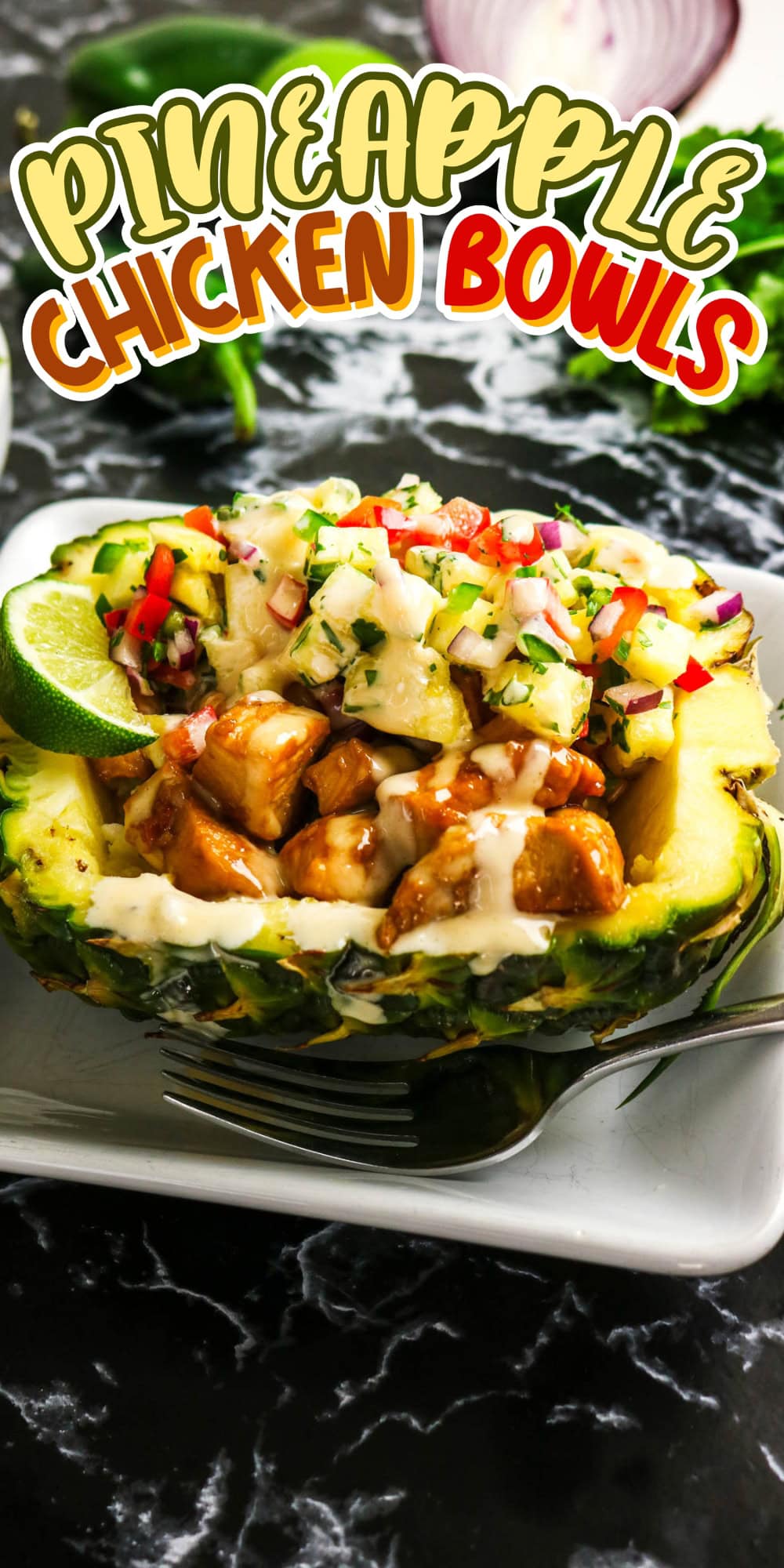Chicken and salsa served in a halved pineapple bowl, with sauce and lime.