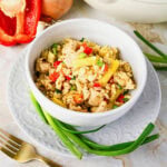 Bowl of fried rice with chicken, pineapple, peppers, and green onions.
