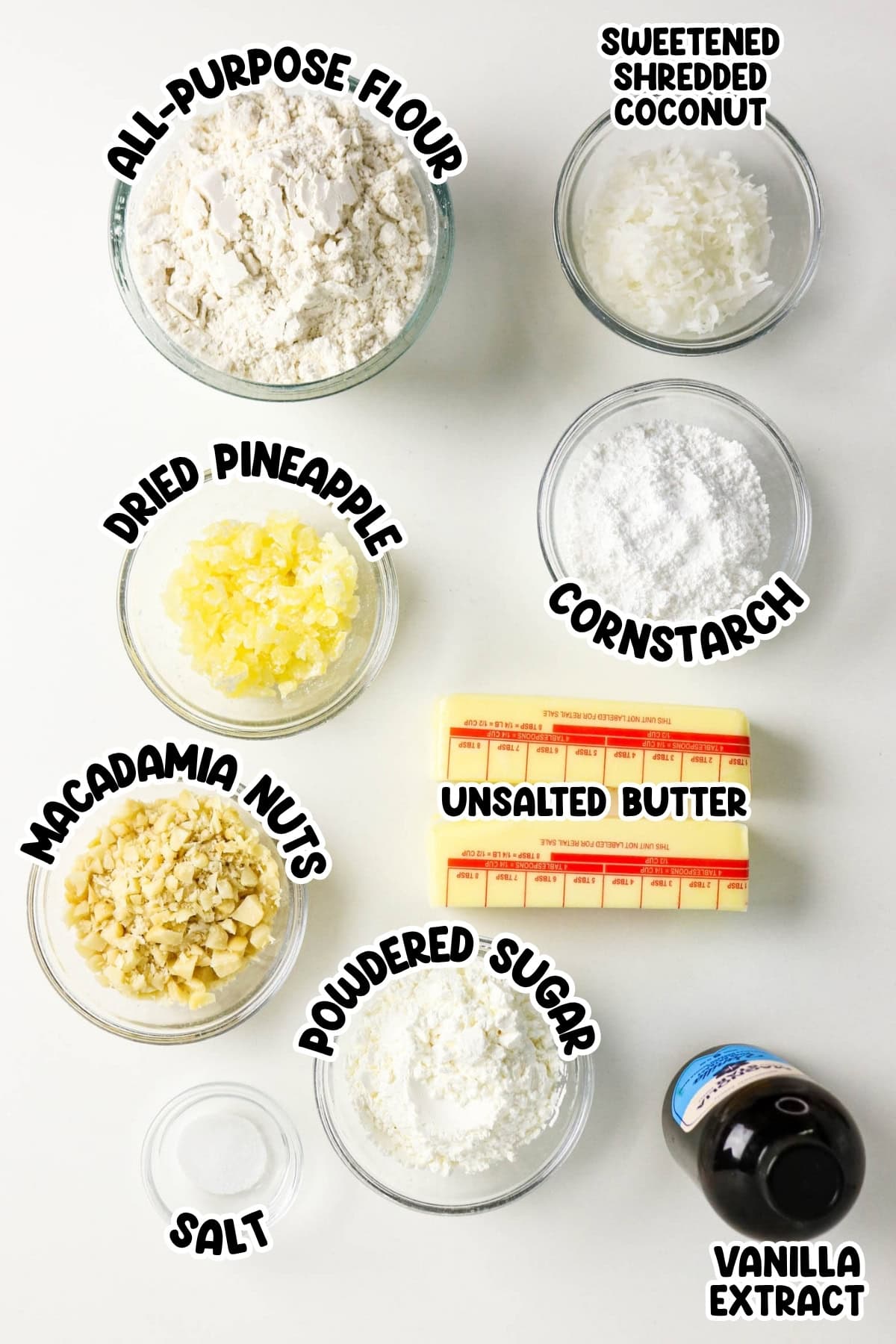 Baking ingredients labeled in bowls, including flour, coconut, nuts, and butter.
