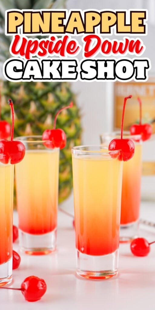 Four pineapple upside down cake shots with cherries, pineapple in background.