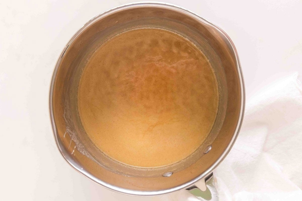 A pot filled with caramel sauce.