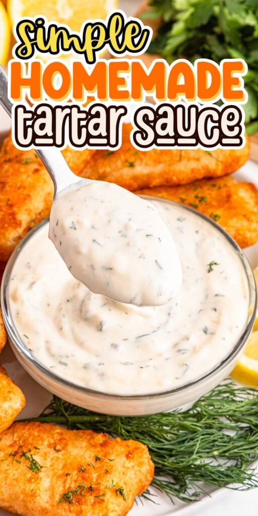A spoonful of tartar sauce above a bowl, with fish sticks and herbs nearby.