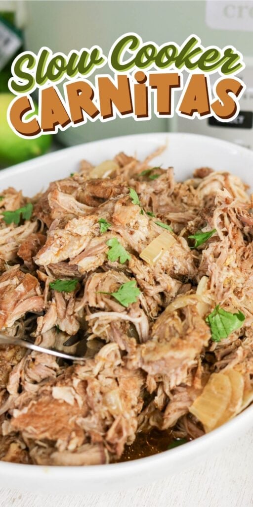Shredded slow cooker carnitas garnished with cilantro in a white dish.