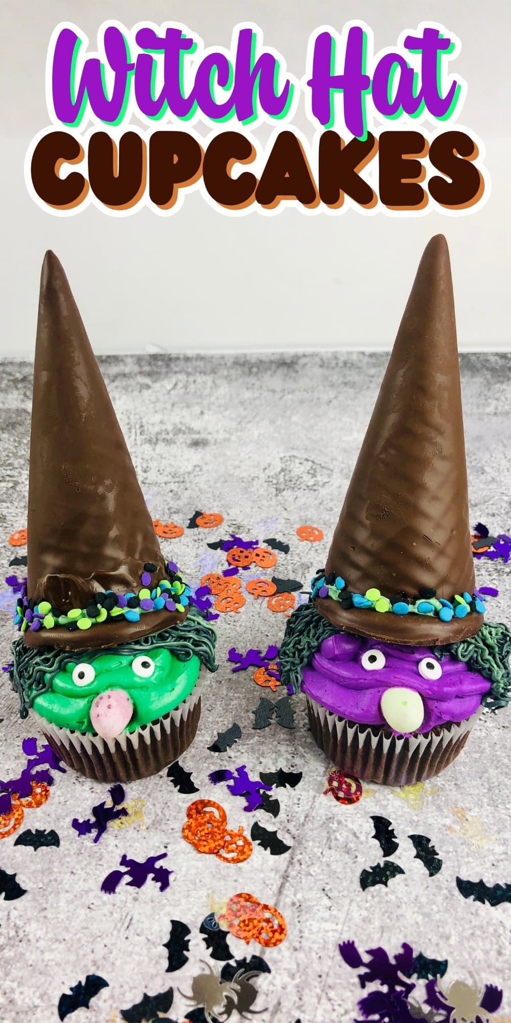 Two cupcakes decorated as witches with tall chocolate hats and colorful faces.