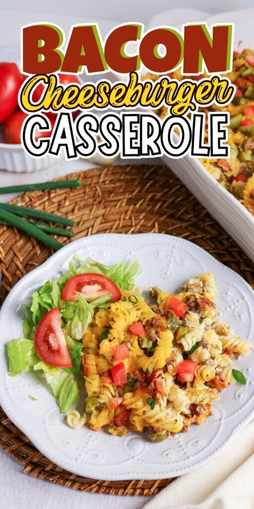 Plate of bacon cheeseburger casserole with lettuce and tomato on a white plate.