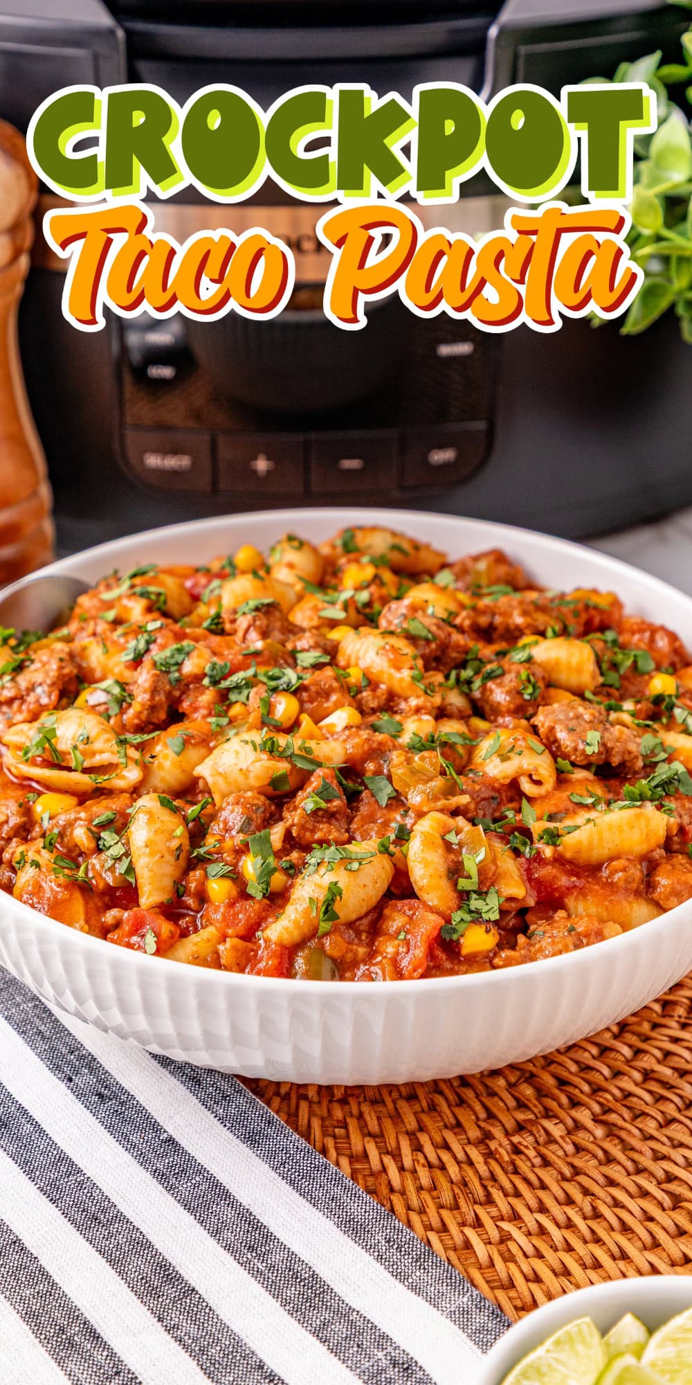 Bowl of taco pasta in front of a crockpot.