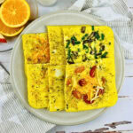Four square egg omelets with various vegetables on a plate.