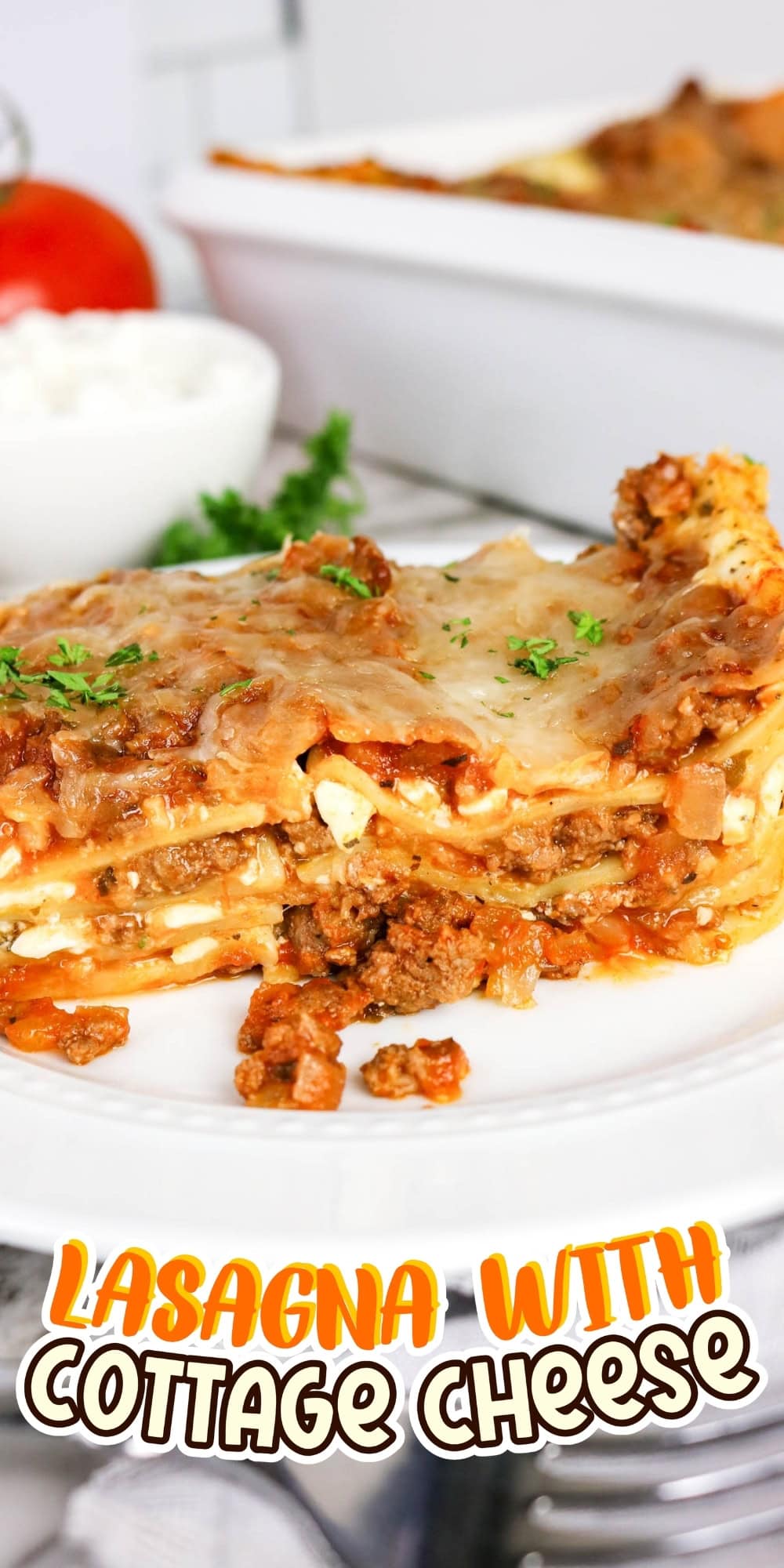 A slice of lasagna with meat sauce and cheese on a white plate.