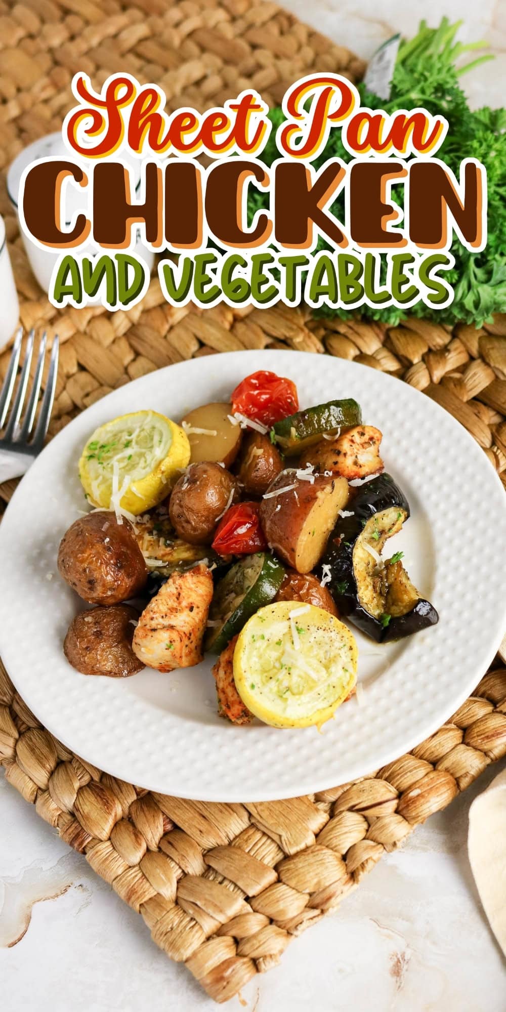 Plate of sheet pan chicken with potatoes, zucchini, squash, and tomatoes.
