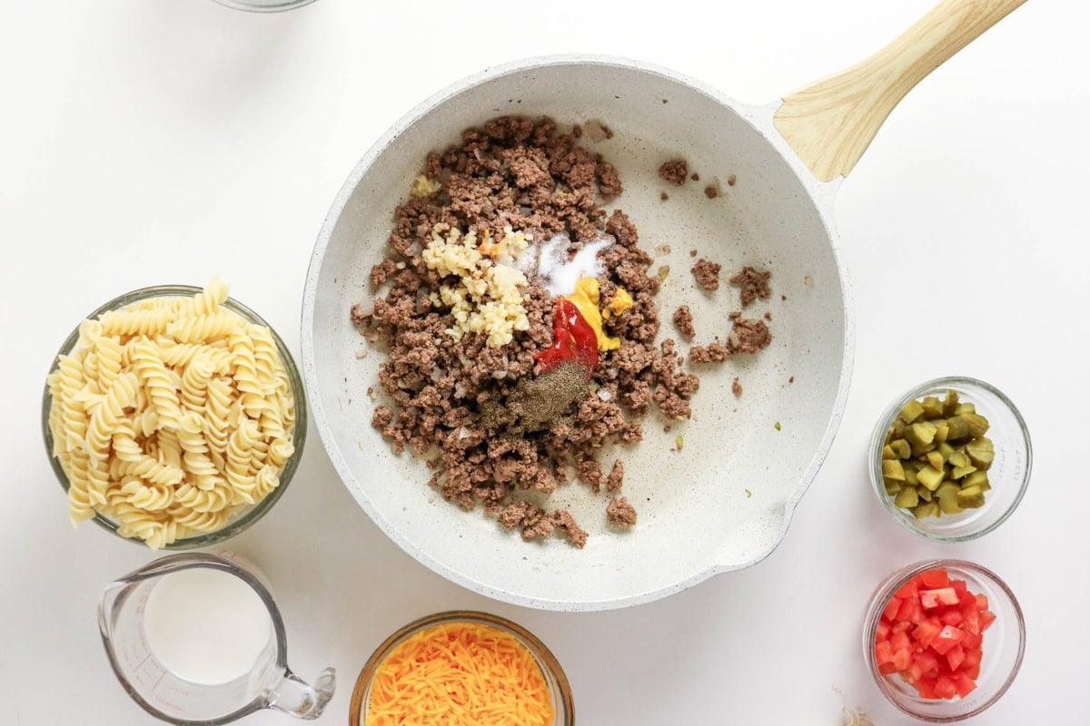 Ground beef, garlic, ketchup, spices, pasta, pickles, cheese, milk, tomatoes.