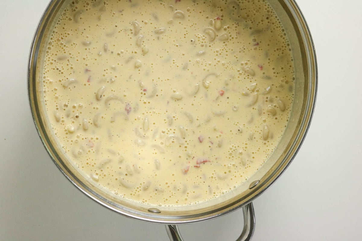 Pot filled with creamy macaroni and cheese sauce seen from above.