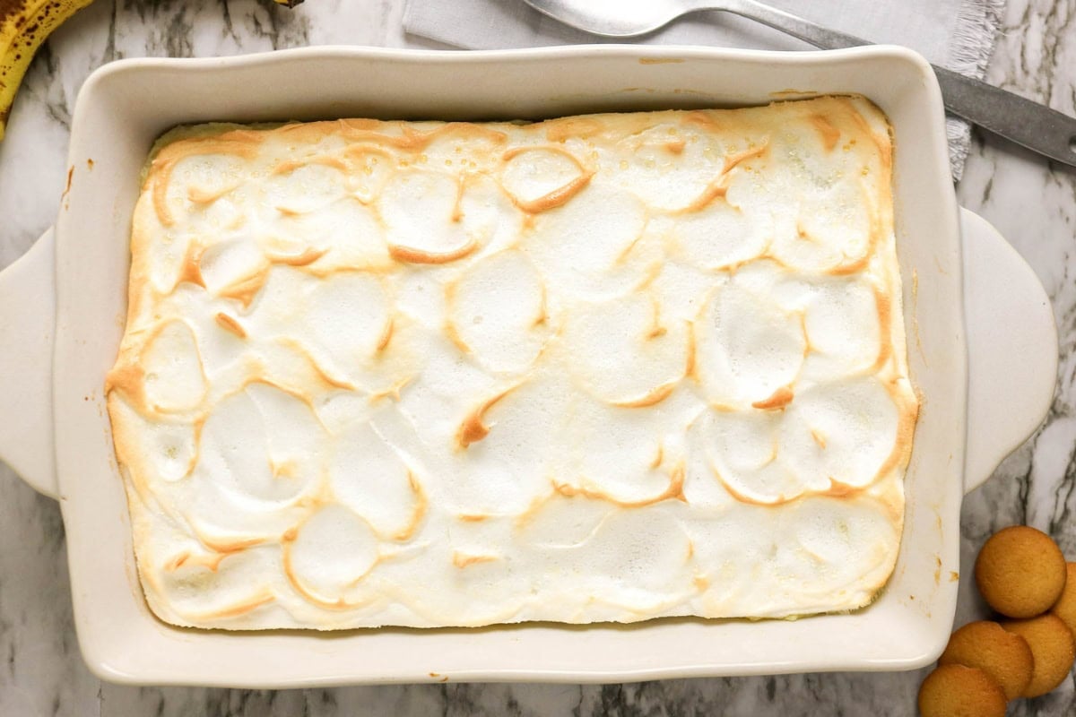 Baked dessert with golden meringue topping in a rectangular white dish.