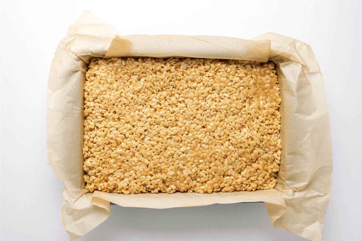 Rice Krispies treats in a parchment-lined rectangular baking dish.