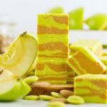 Green and caramel fudge squares with sliced green apples around them.