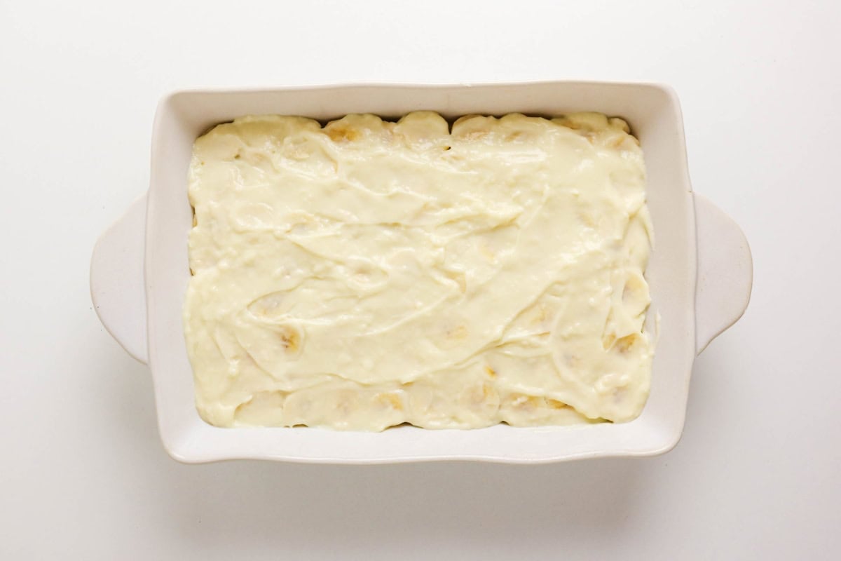 A white casserole dish filled with a creamy, smooth mixture on top.